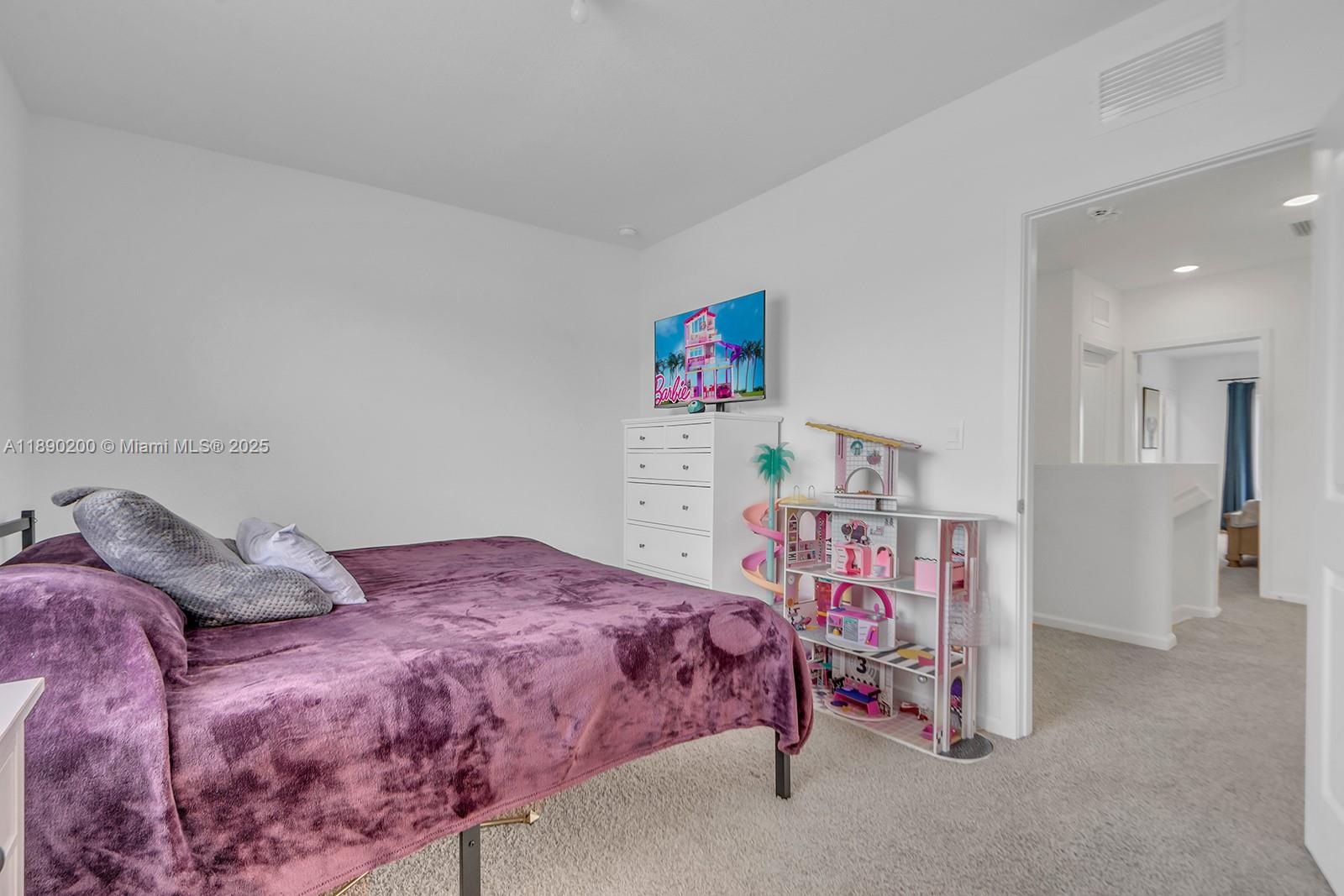1772 Southeast 8th Street Homestead, FL 33033 - Photo 20 of 42 a bedroom with a bed and a book shelf