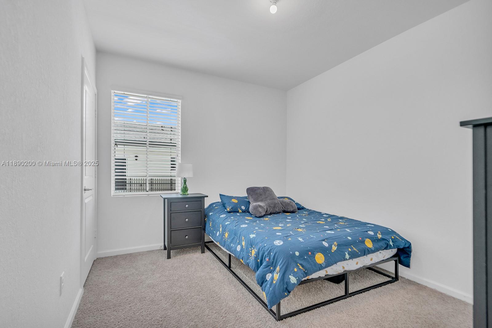 1772 Southeast 8th Street Homestead, FL 33033 - Photo 22 of 42 a bedroom with a bed and window