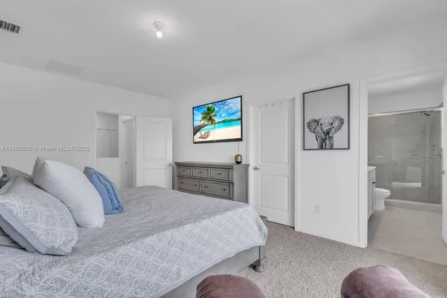 a bedroom with a bed and a couch