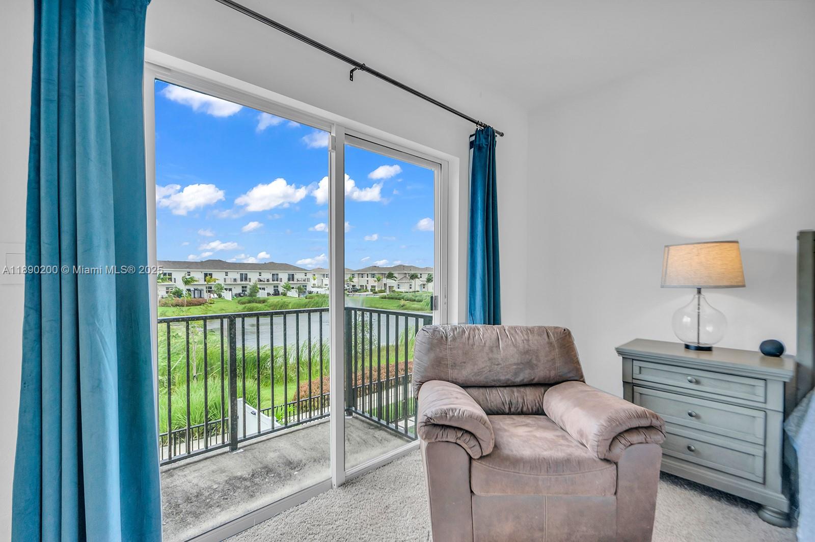 1772 Southeast 8th Street Homestead, FL 33033 - Photo 28 of 42 a living room with furniture a lamp and a window