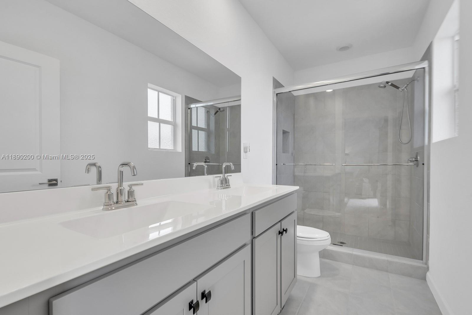 1772 Southeast 8th Street Homestead, FL 33033 - Photo 29 of 42 a bathroom with a sink a toilet and shower