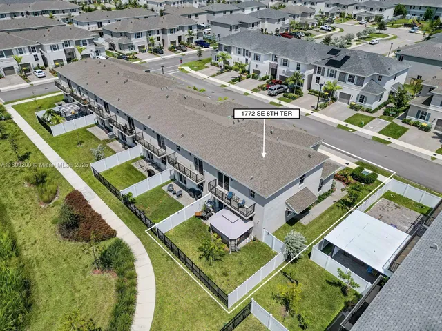 an aerial view of a house with a swimming pool