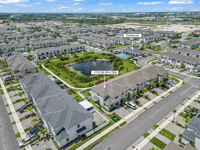 an aerial view of residential houses with outdoor space