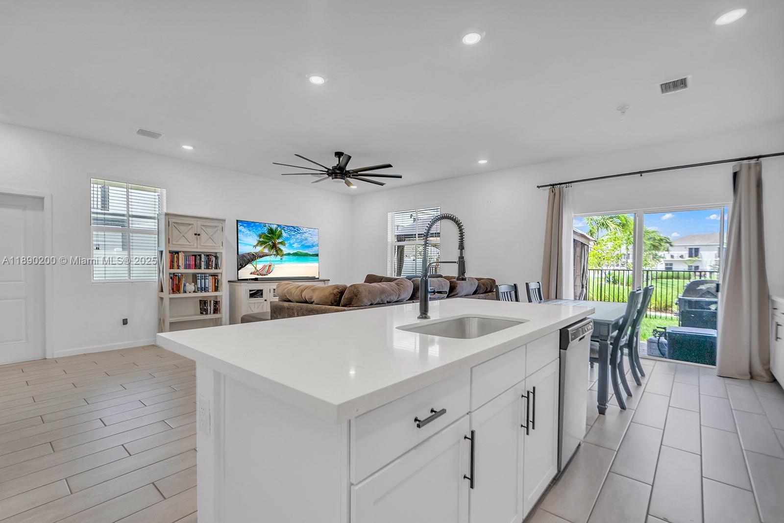 1772 Southeast 8th Street Homestead, FL 33033 - Photo 8 of 42 a kitchen with stainless steel appliances a sink a counter top space cabinets and a couch