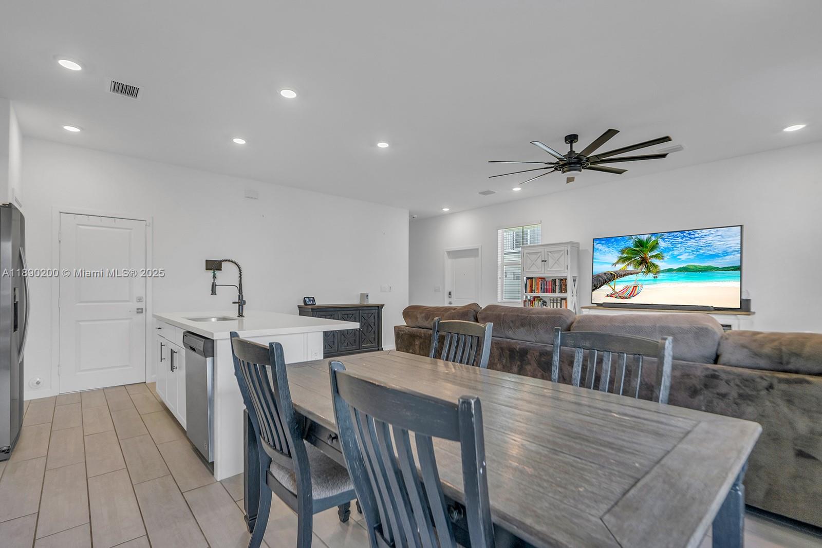 1772 Southeast 8th Street Homestead, FL 33033 - Photo 10 of 42 a view of a dining room with furniture and a ceiling fan