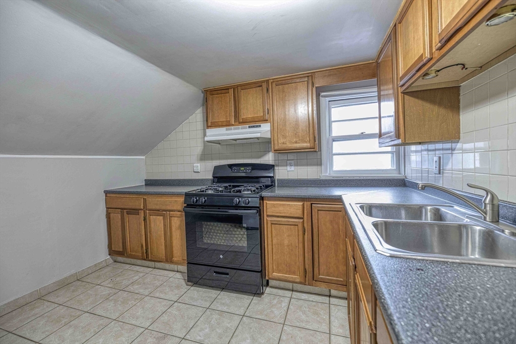 1636 South Main Street, Unit 3 Fall River, MA 02724 - Photo 5 of 14 a kitchen with granite countertop a sink and a stove top oven