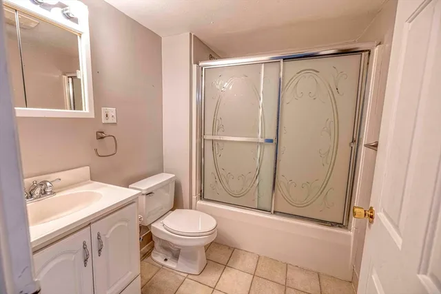 a bathroom with a toilet a sink and a shower