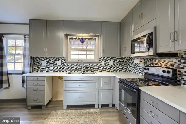 a kitchen with granite countertop a stove and a sink