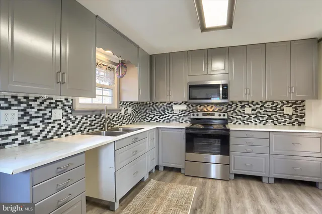 a kitchen with a sink stove and cabinets
