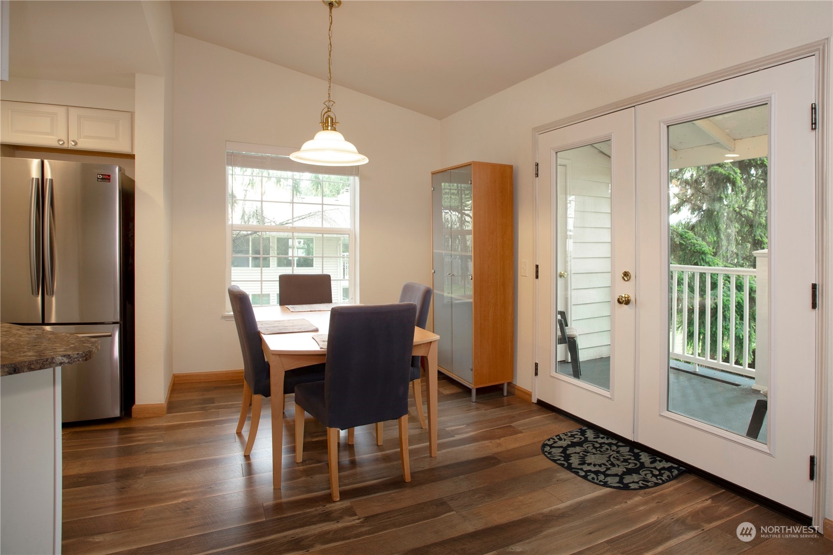 8653 Avondale Road Northeast, Unit D207 Redmond, WA 98052 - Photo 3 of 21 a dining room with furniture a chandelier and wooden floor