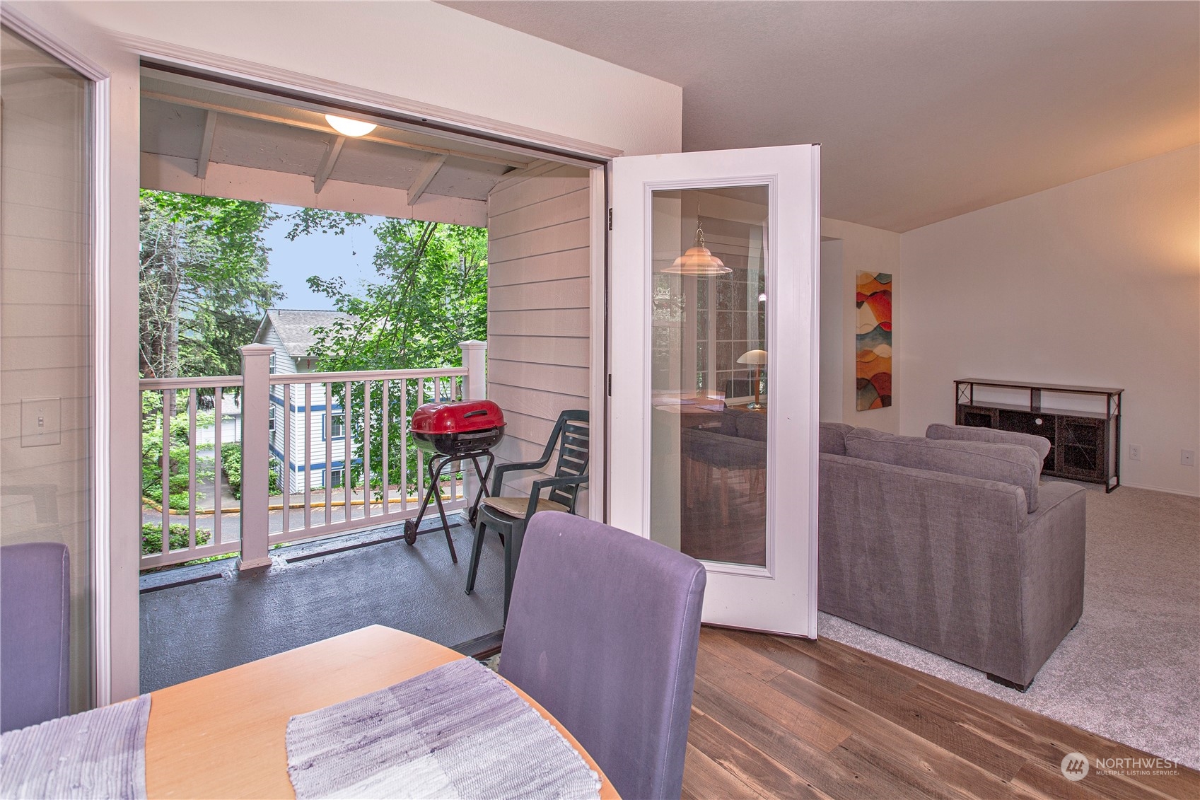 8653 Avondale Road Northeast, Unit D207 Redmond, WA 98052 - Photo 5 of 21 a living room with furniture a wooden floor and a large window