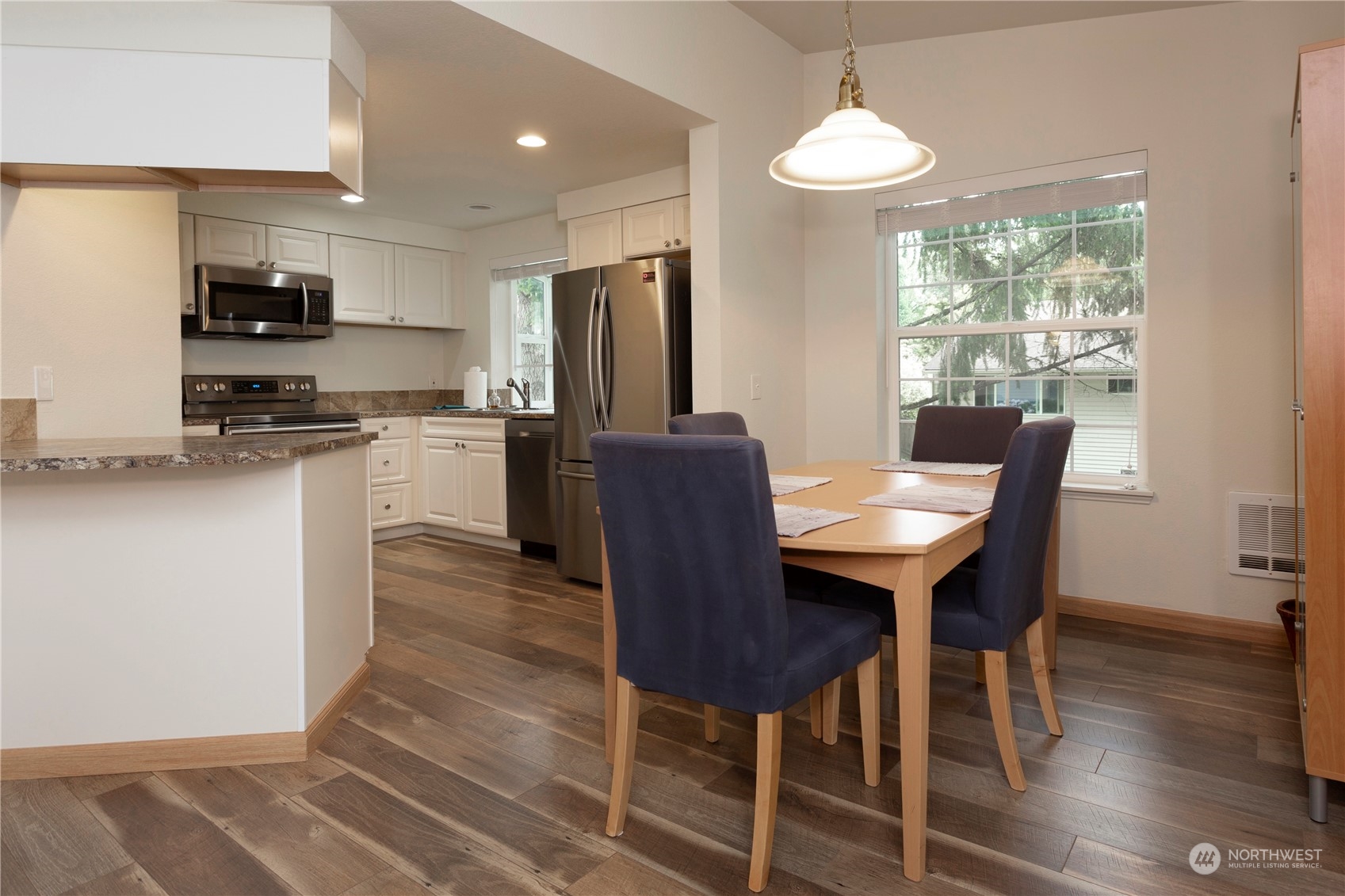 8653 Avondale Road Northeast, Unit D207 Redmond, WA 98052 - Photo 6 of 21 a view of a dining room with furniture window and wooden floor