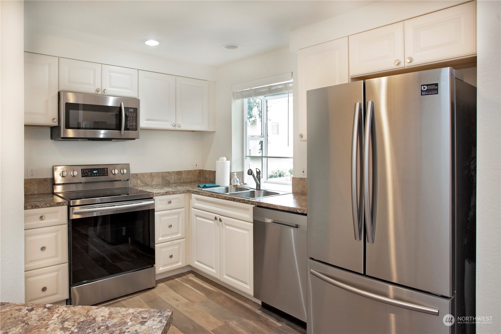 8653 Avondale Road Northeast, Unit D207 Redmond, WA 98052 - Photo 7 of 21 a kitchen with stainless steel appliances a stove a sink and a refrigerator