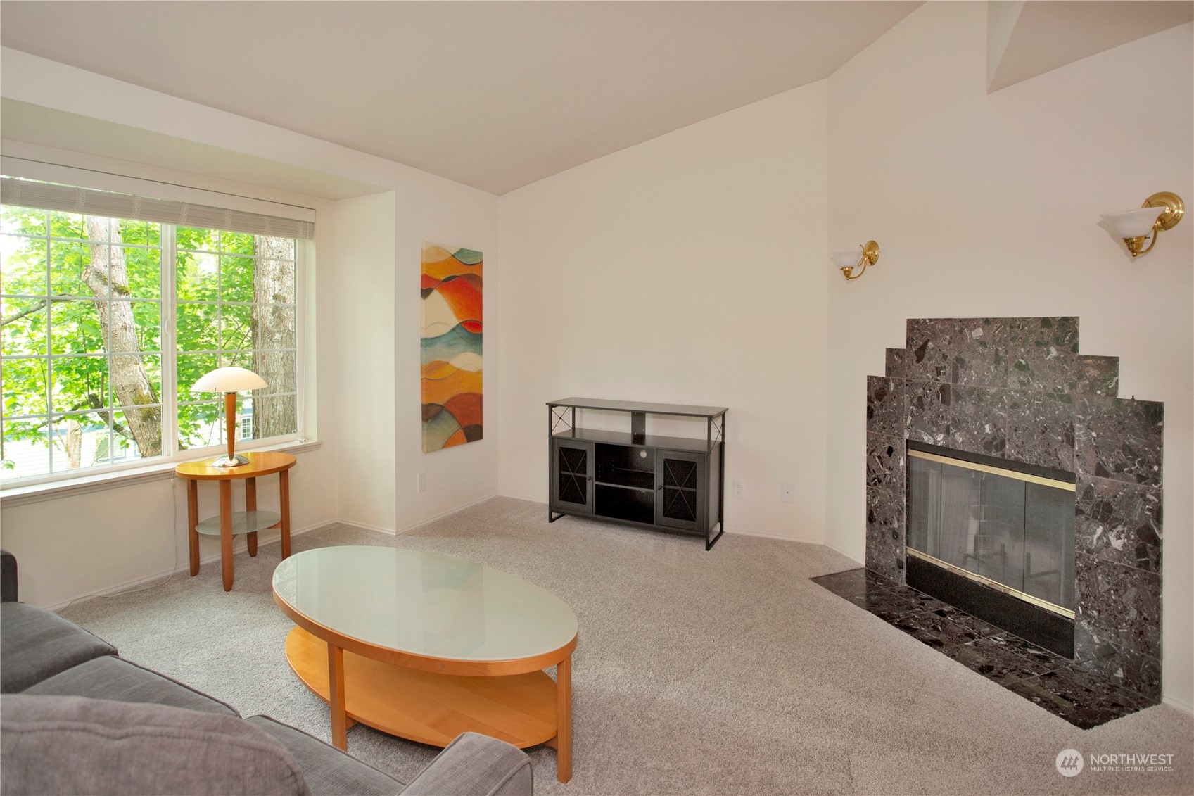 8653 Avondale Road Northeast, Unit D207 Redmond, WA 98052 - Photo 8 of 21 a living room with furniture a flat screen tv and a fireplace
