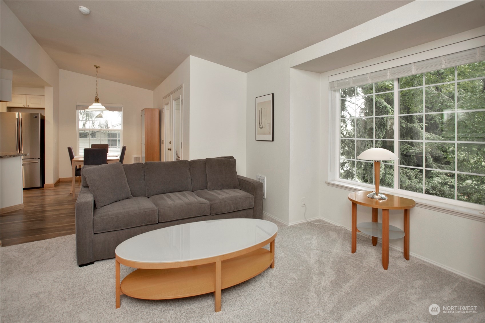 8653 Avondale Road Northeast, Unit D207 Redmond, WA 98052 - Photo 9 of 21 a living room with furniture and a large window