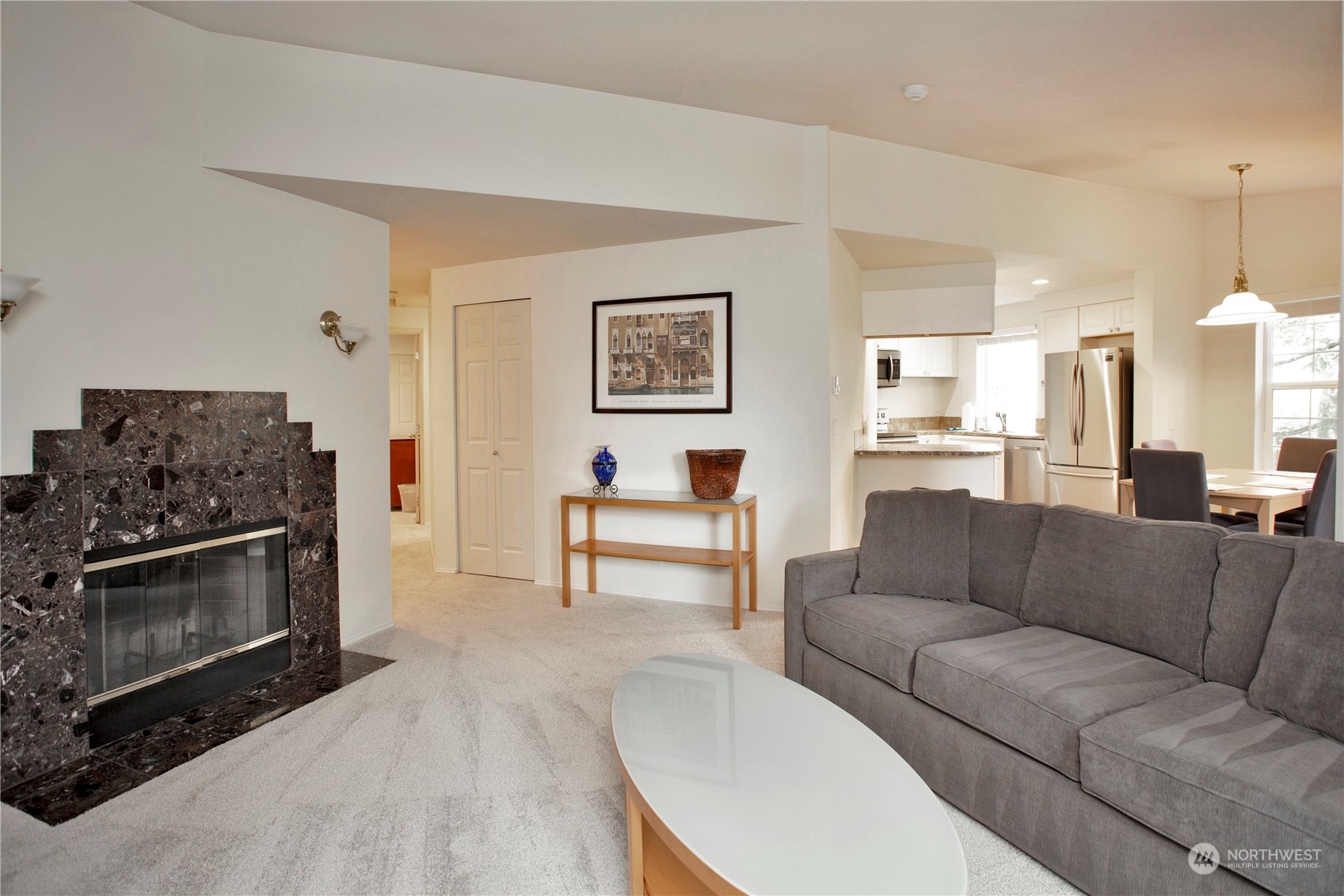 8653 Avondale Road Northeast, Unit D207 Redmond, WA 98052 - Photo 10 of 21 a living room with furniture and a fireplace