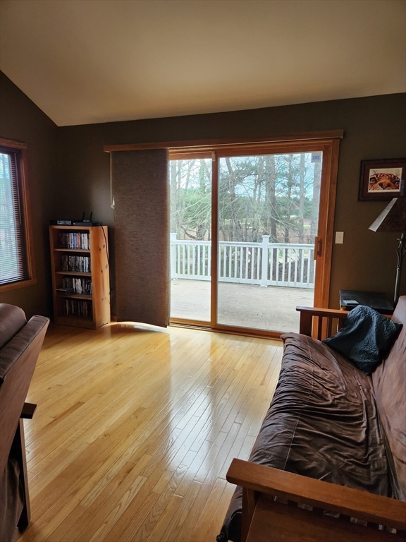 153 County Road Rochester, MA 02576 - Photo 6 of 39 a spacious bedroom with a bed and wooden floor