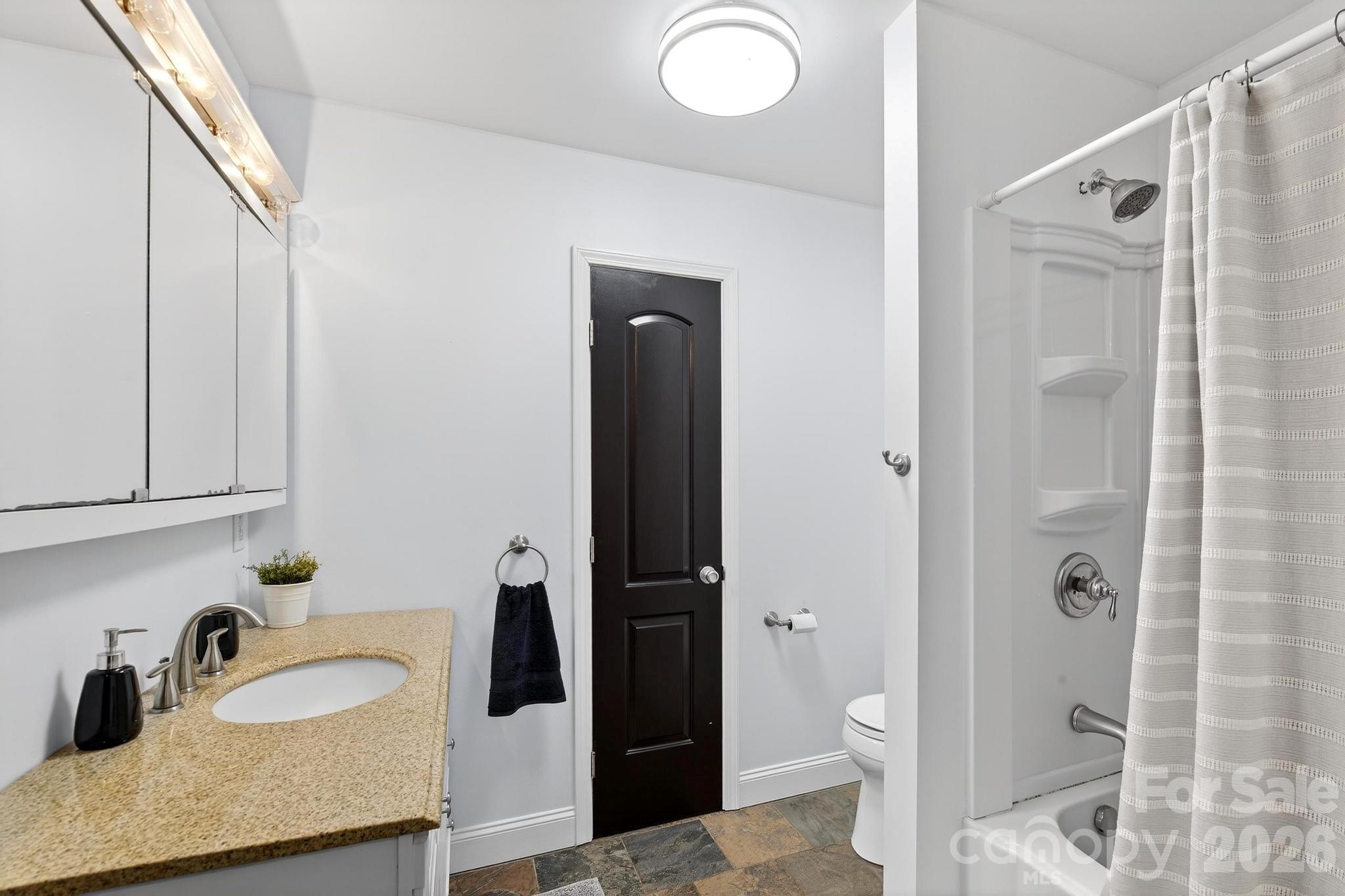 343 Hoyles Creek Road Dallas, NC 28034 - Photo 14 of 31 a bathroom with a granite countertop sink toilet and shower