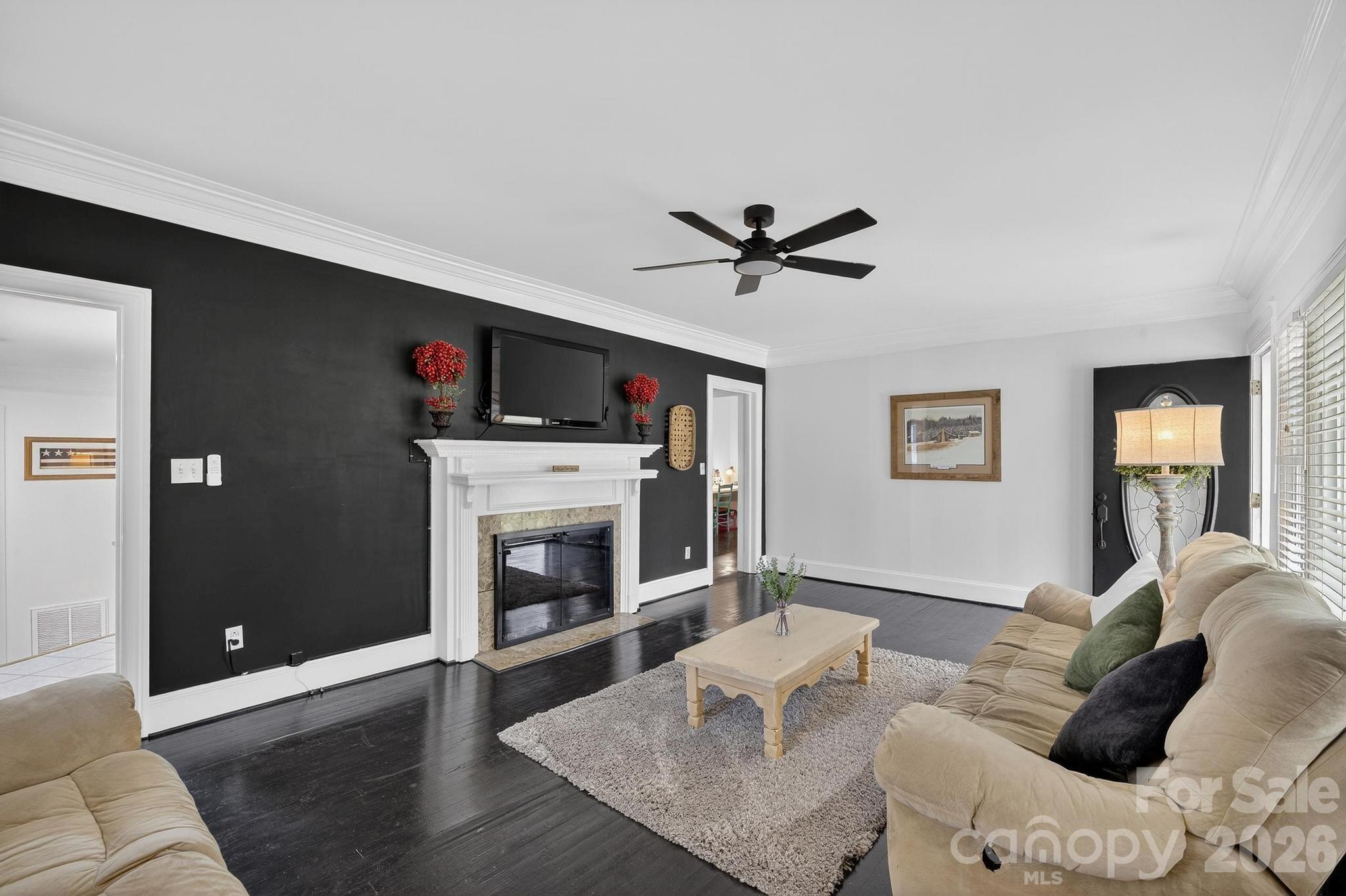 343 Hoyles Creek Road Dallas, NC 28034 - Photo 16 of 31 a living room with furniture a flat screen tv and a fireplace