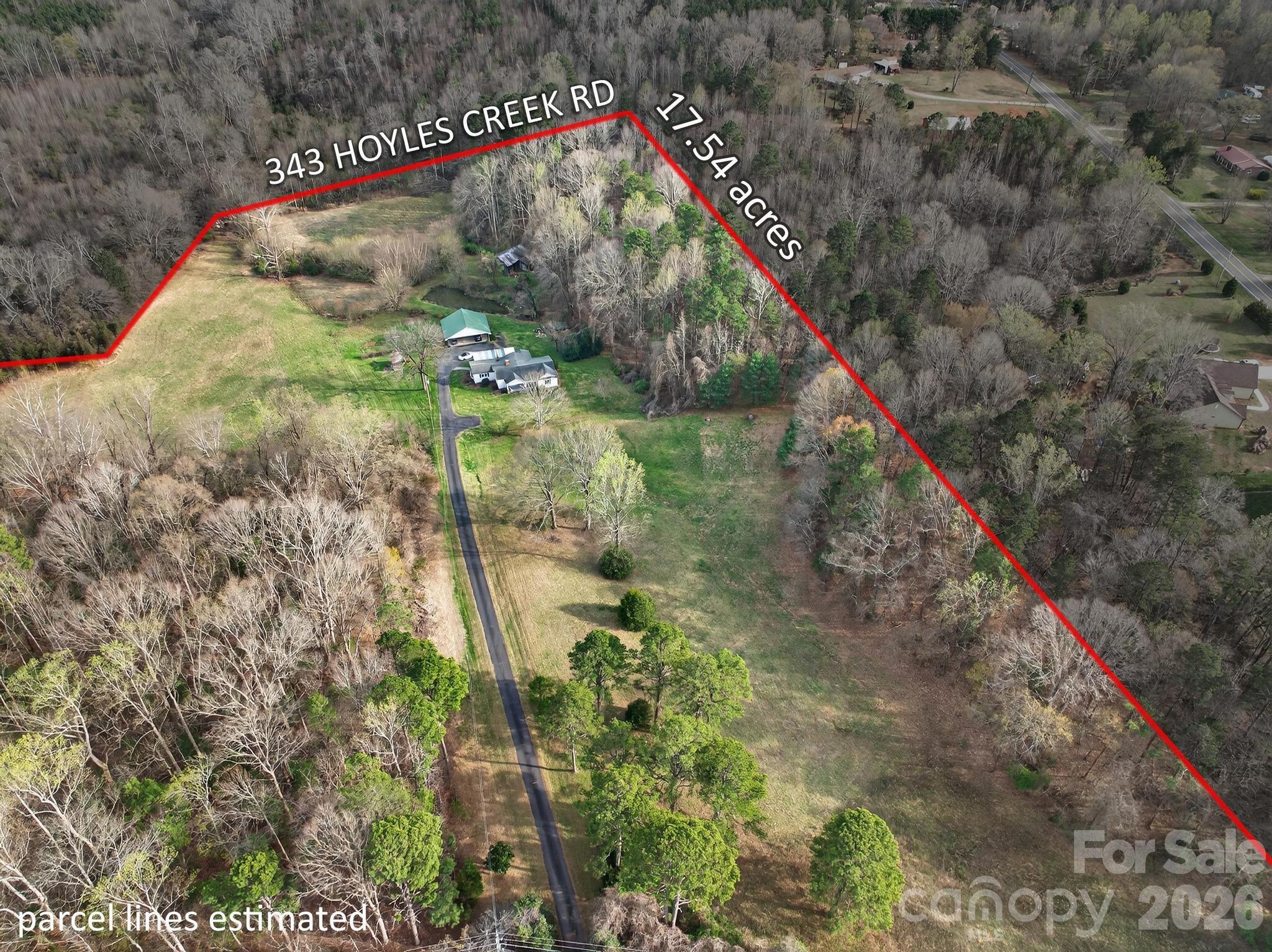 343 Hoyles Creek Road Dallas, NC 28034 - Photo 21 of 31 a backyard of a building with large trees and plants