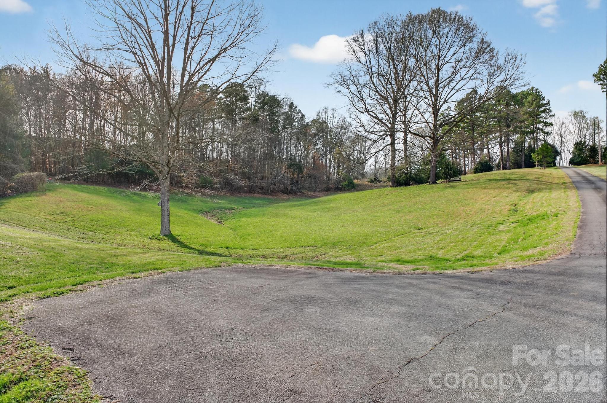 343 Hoyles Creek Road Dallas, NC 28034 - Photo 26 of 31 a view of a big yard with large trees