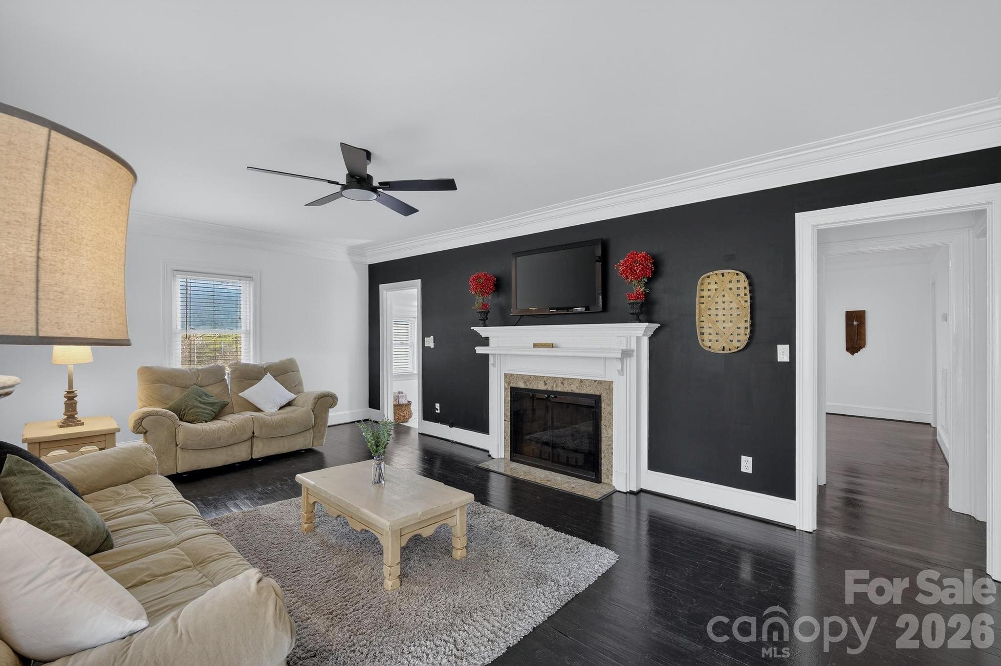 343 Hoyles Creek Road Dallas, NC 28034 - Photo 3 of 31 a living room with furniture a fireplace and a flat screen tv