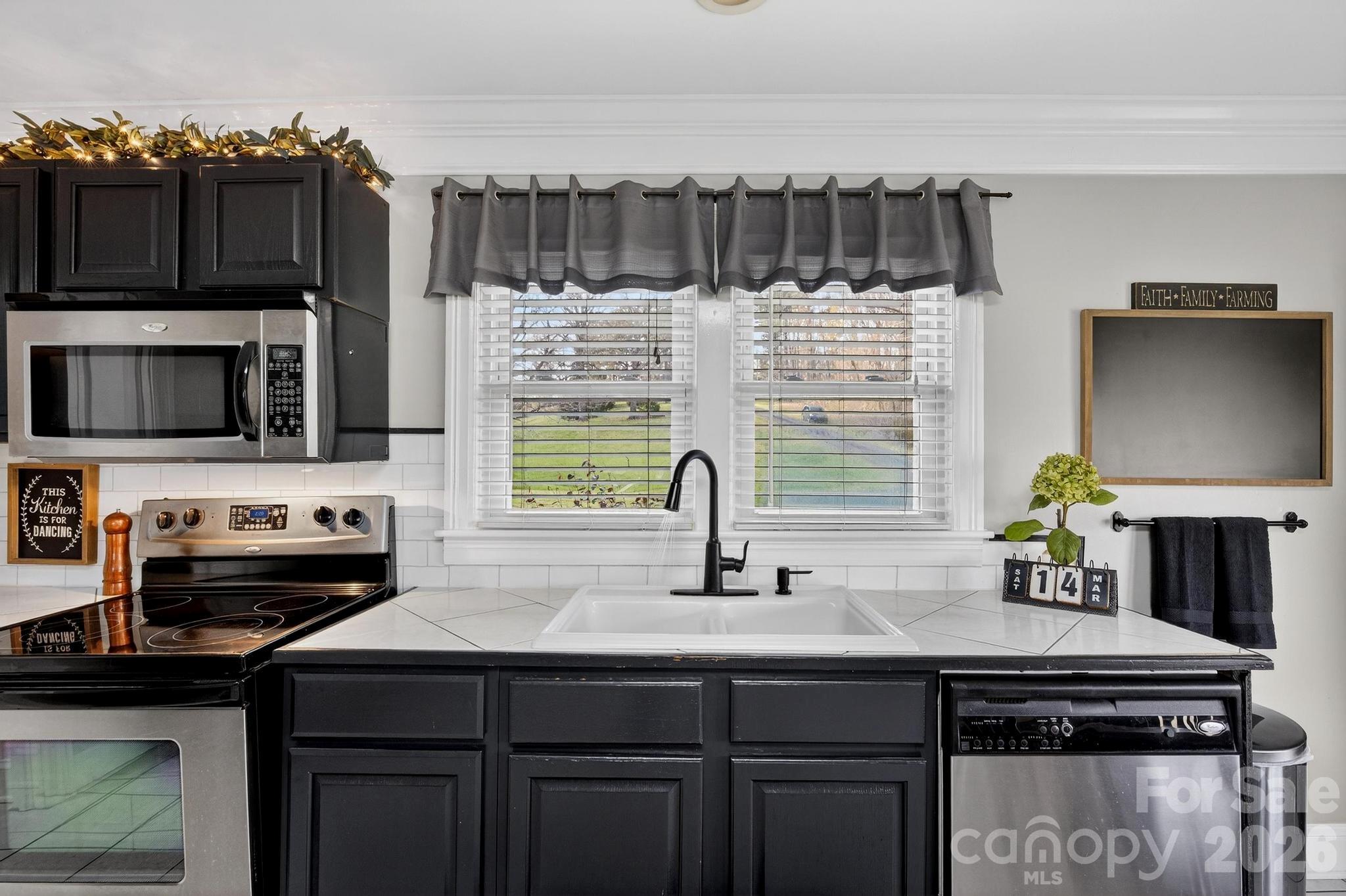 343 Hoyles Creek Road Dallas, NC 28034 - Photo 6 of 31 a kitchen with a sink a stove and cabinets