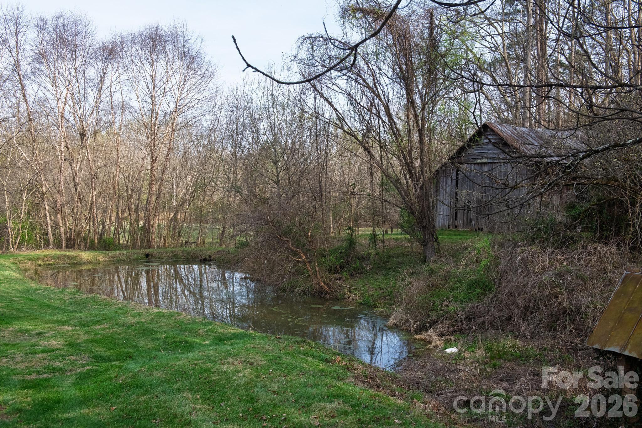 343 Hoyles Creek Road Dallas, NC 28034 - Photo 10 of 31 a view of a backyard with large trees