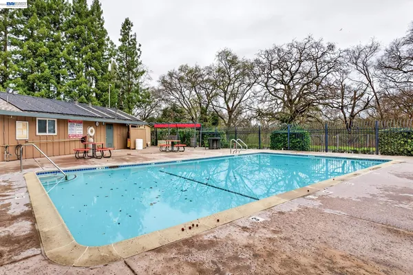 swimming pool view with a seating space and a garden view