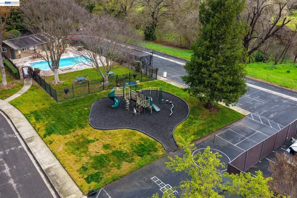 an aerial view of a backyard with swimming pool