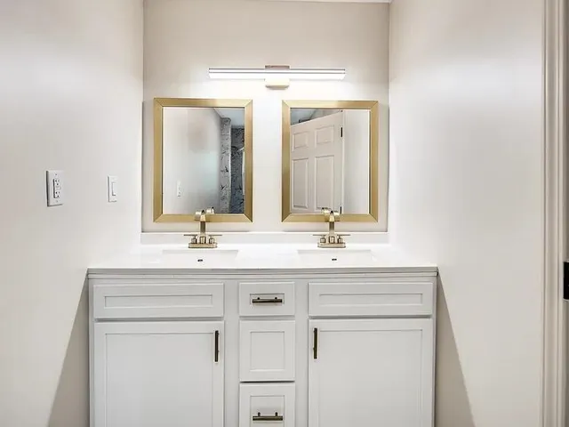 a bathroom with a sink vanity and a mirror