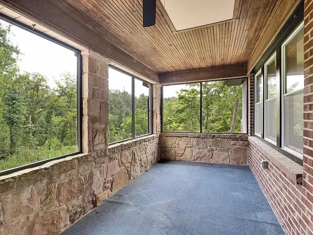 a large room with a large window and furniture