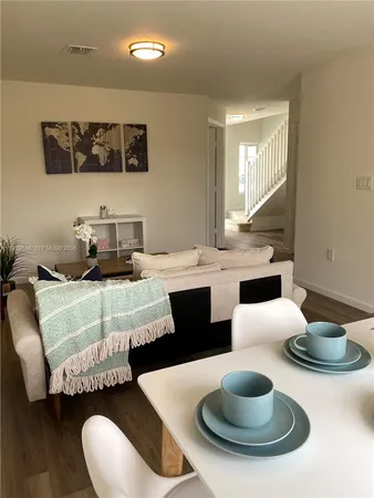 a living room with furniture and a large mirror