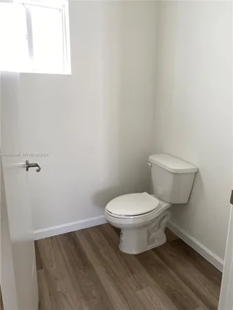 a white toilet sitting next to a white sink