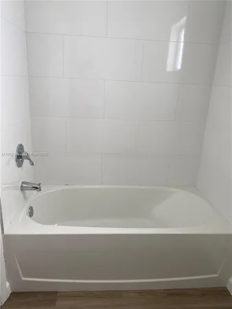 a bathroom with bathtub and shower