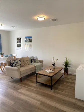a living room with furniture and a potted plant