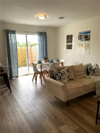 a living room with furniture and large windows