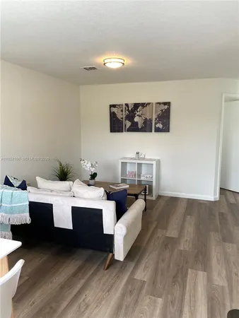 a living room with a couch and cabinets