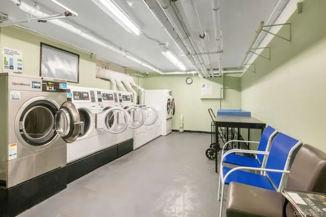 a utility room with stainless steel appliances granite countertop lots of furniture