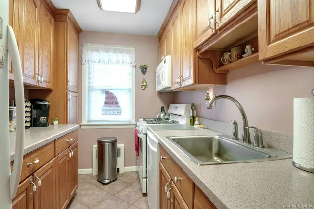 a kitchen with stainless steel appliances granite countertop a sink a counter space and cabinets