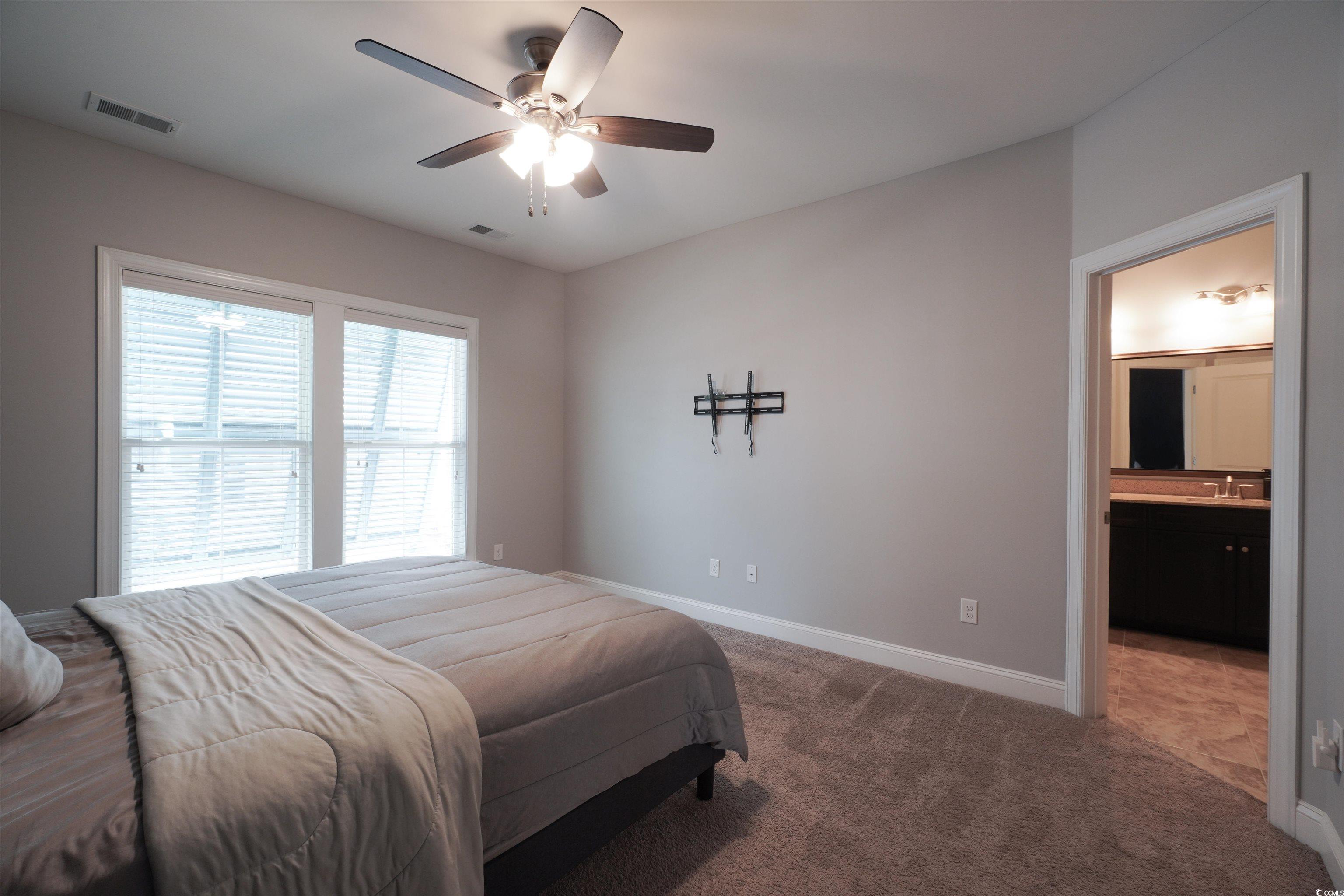 100 Splendor Circle Murrells Inlet, SC 29576 - Photo 25 of 40 Bedroom featuring carpet flooring, ceiling fan, and ensuite bath