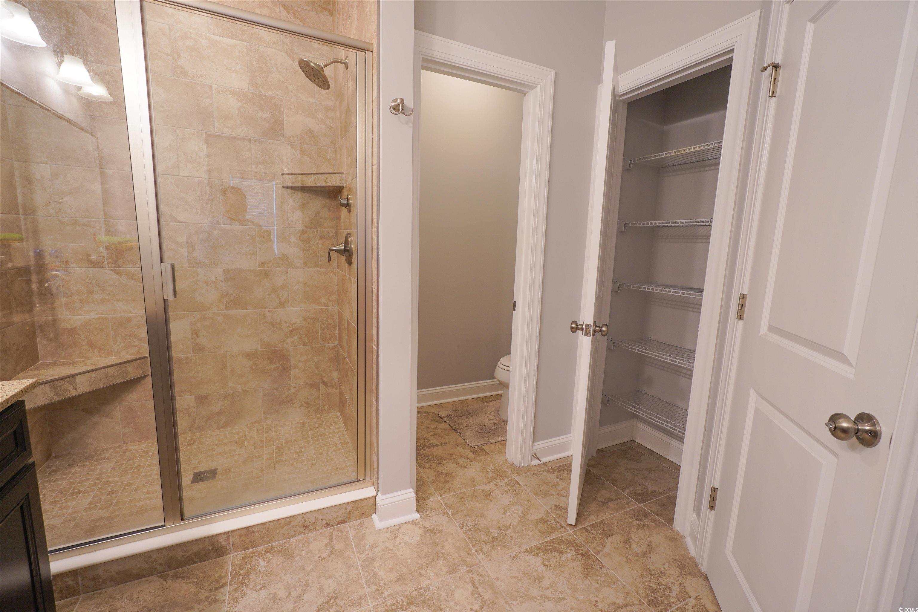 100 Splendor Circle Murrells Inlet, SC 29576 - Photo 28 of 40 Full bath with a shower stall and light tile patterned floors and linen closet