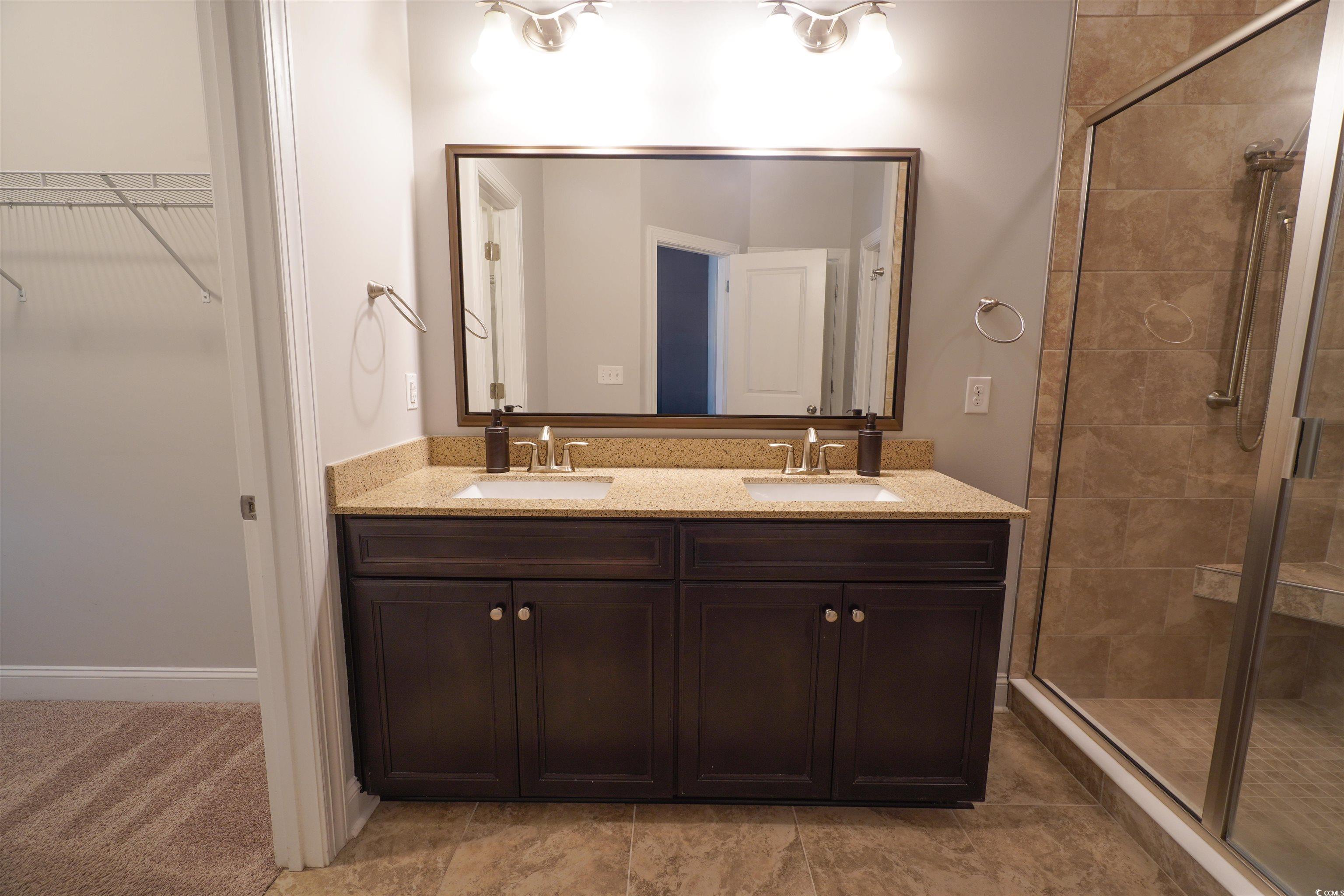 100 Splendor Circle Murrells Inlet, SC 29576 - Photo 29 of 40 Full bath with a stall shower, double vanity, and a walk in closet