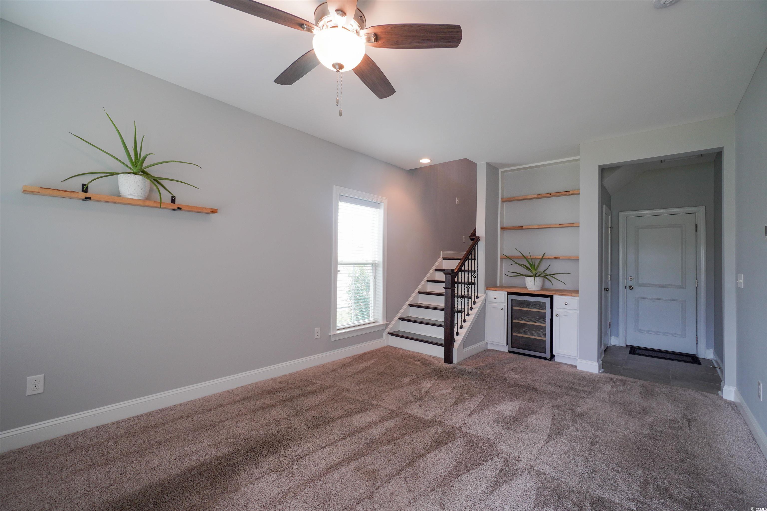 100 Splendor Circle Murrells Inlet, SC 29576 - Photo 8 of 40 beverage cooler, light carpet, ceiling fan, and a bar