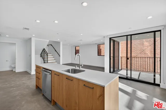 a kitchen with stainless steel appliances granite countertop a sink and a stove