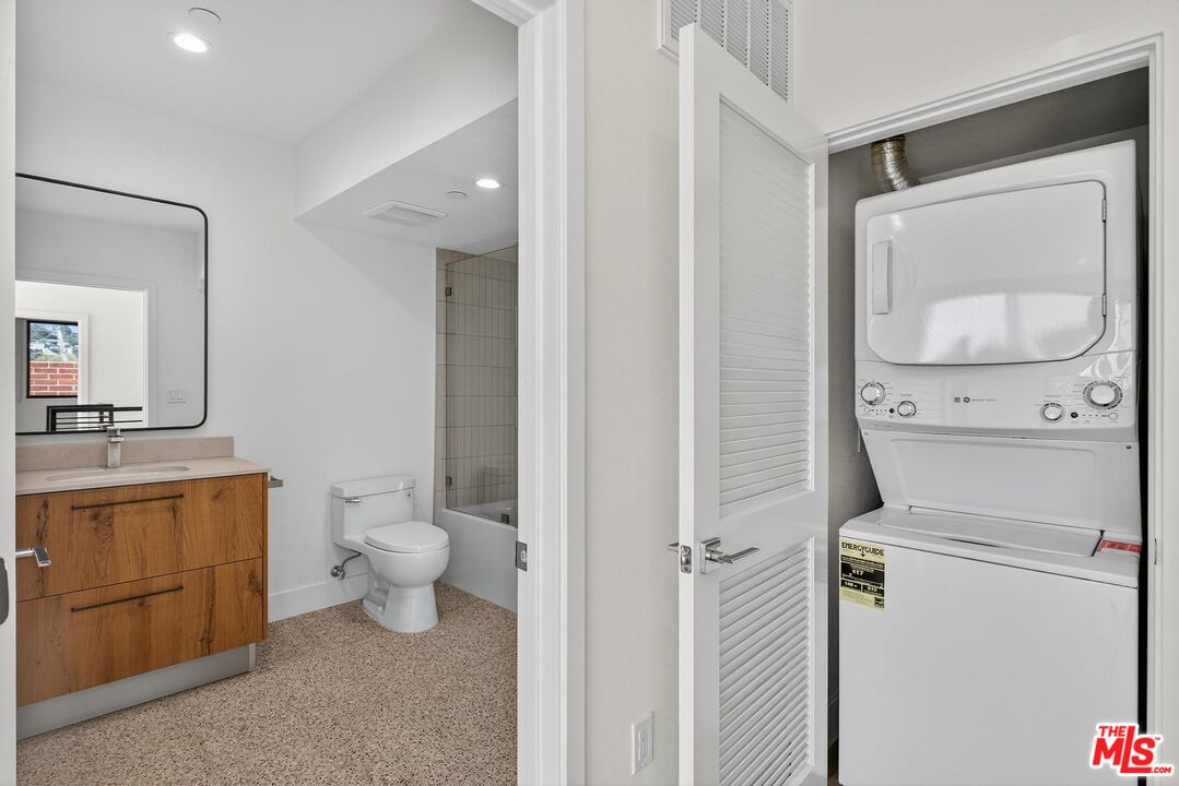 2412 Eads Street, Unit 7 Los Angeles, CA 90031 - Photo 20 of 29 a bathroom with a toilet sink vanity and mirror