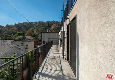 a view of balcony with wooden floor and fence