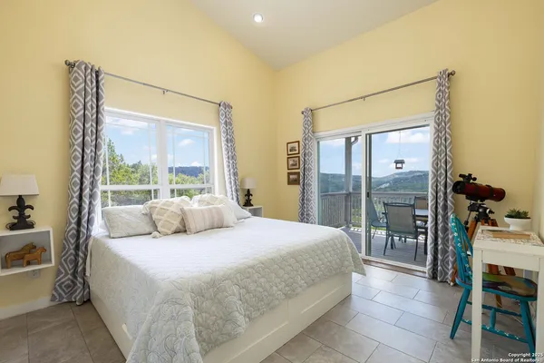 a bedroom with a large bed and a balcony view