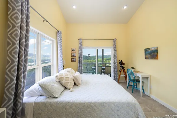 a bedroom with a large bed and a large window