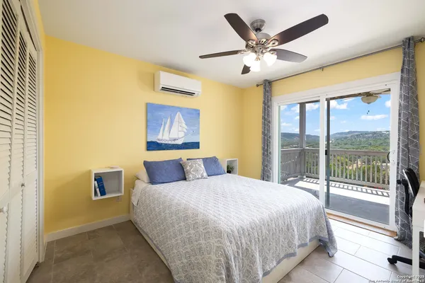 a bedroom with a large bed and a large window